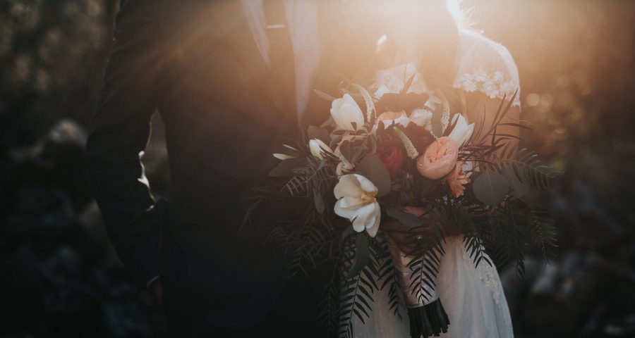 Couple on their wedding day in trendy outfits