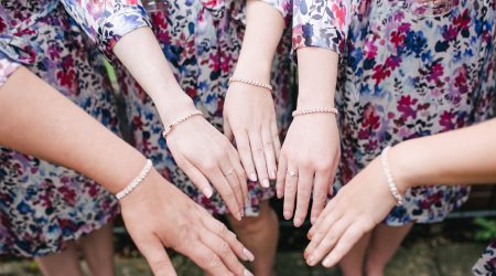 Bridesmaids wear Etsy bracelets and robes