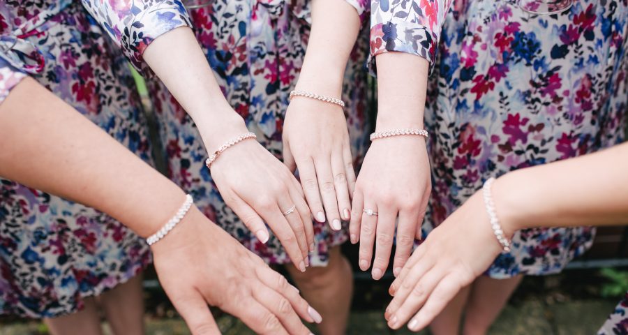 Bridesmaids wear Etsy bracelets and robes
