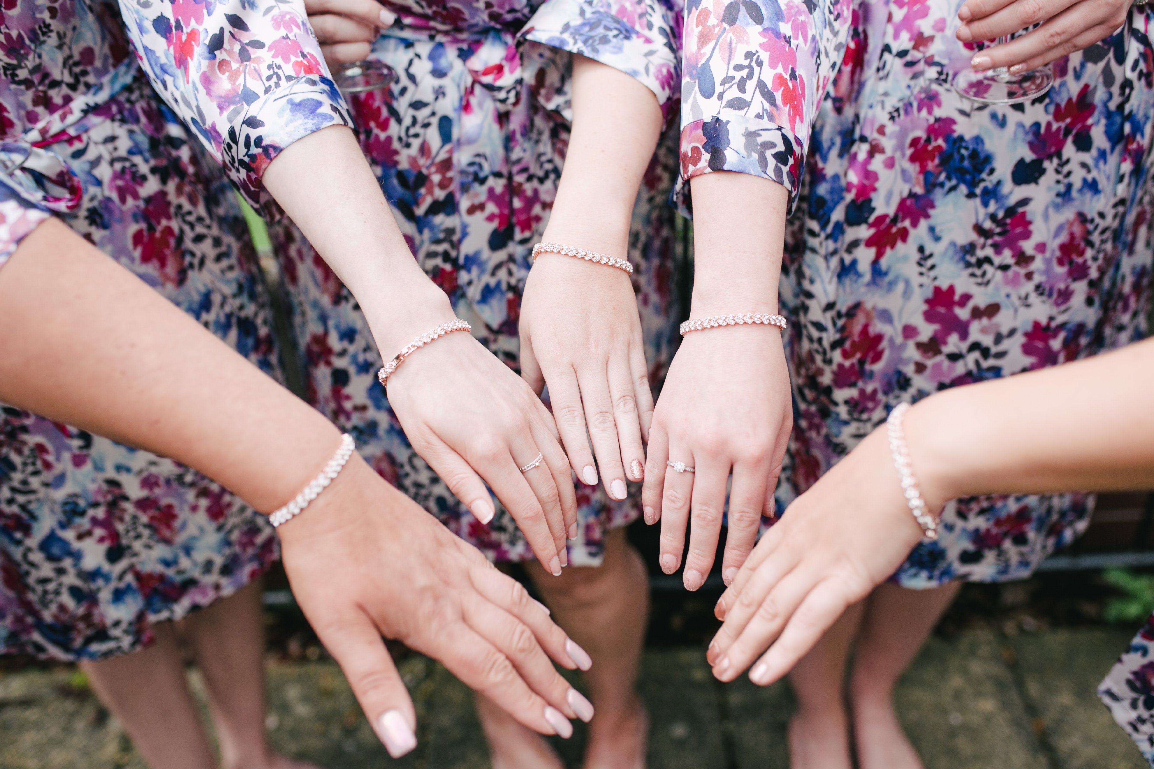 Bridesmaids wear Etsy bracelets and robes