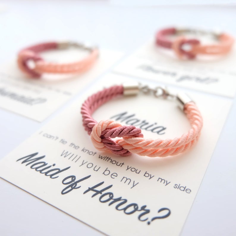 Rope bracelet attached to card that says "will you be my maid of honor?"