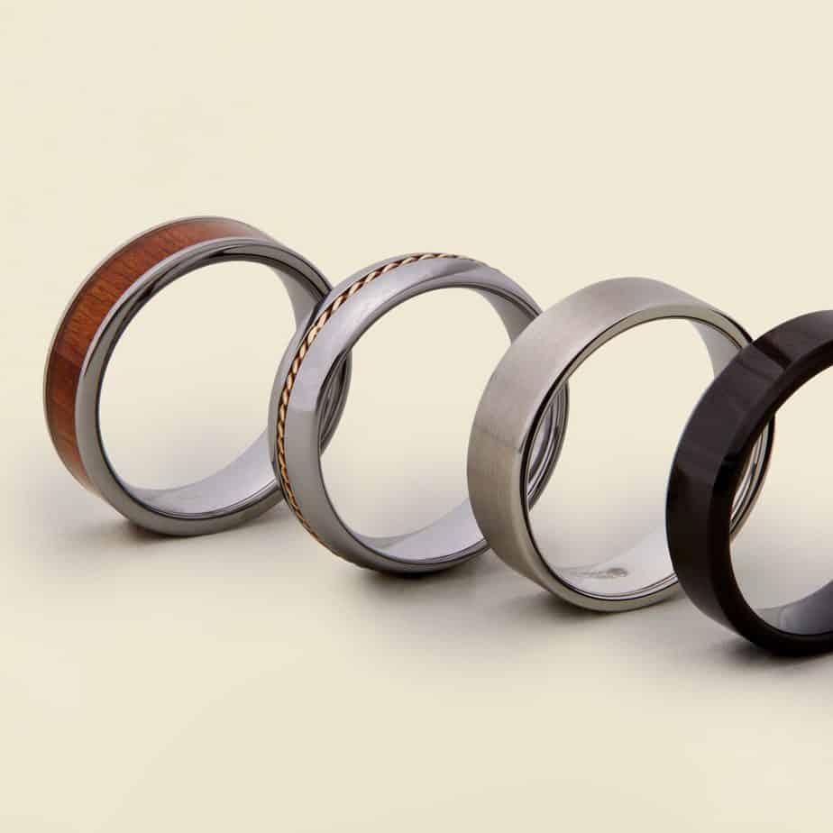 Nontraditional wedding band examples with wood, tungsten, and carbon fiber materials.
