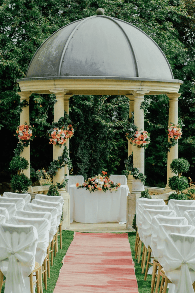 Wedding ceremony venue space decorated with flowers.